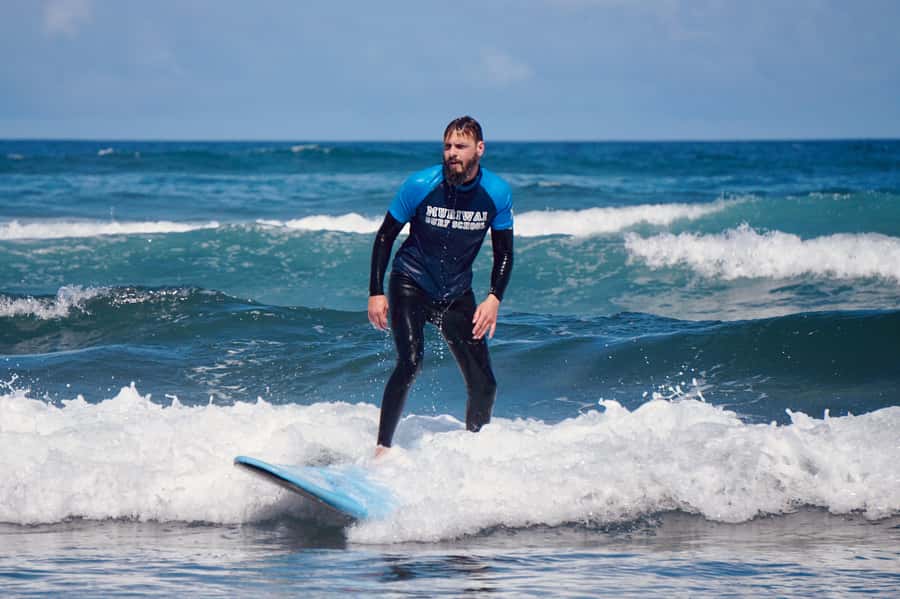 Auckland: Group Surfing Lesson with Muriwai Surf School - The first 30 minutes: board, wetsuit, and standing technique