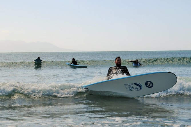 Beginner Surf Lesson at Te Arai Beach - Taking your board into the water
