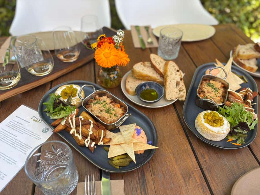 Boutique Winery Half-Day Tour & Vineyard Platter-Style Lunch - Carrick Winery and the platter lunch above Lake Dunstan
