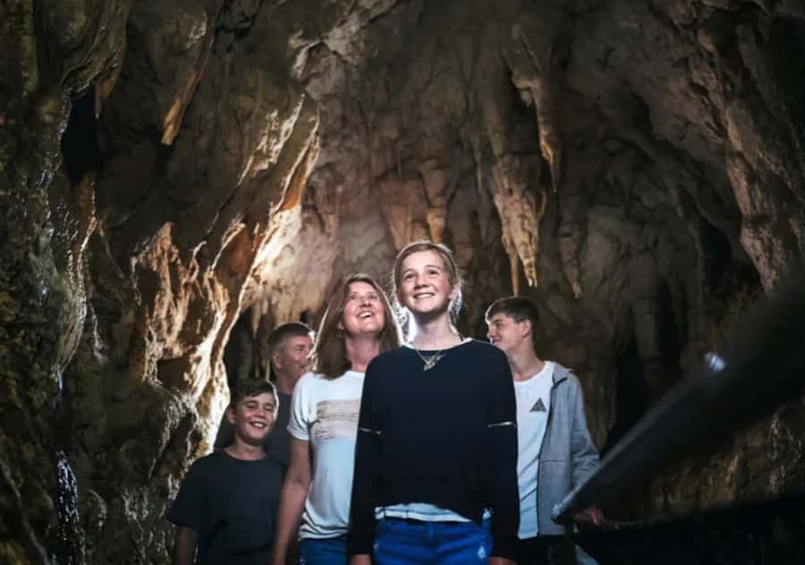 From Auckland: Day Trip to Waitomo Glow Worm Caves - The underground boat ride beneath the glowworms