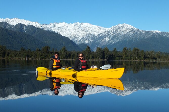 Small-Group Kayak Adventure from Franz Josef Glacier - Paddling across the dark, reflective lake