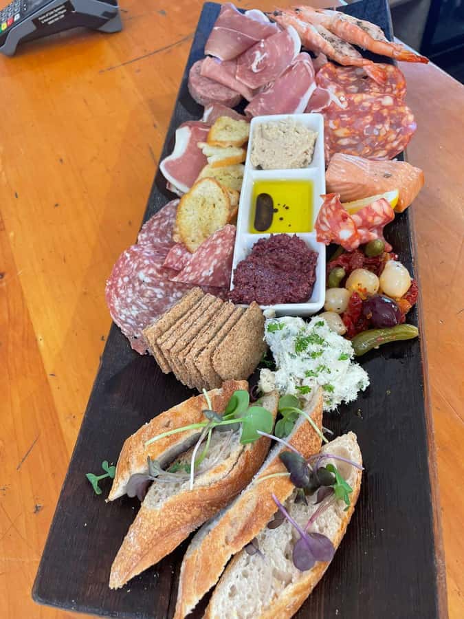 Waiheke: Scenic Taste and Graze Tour with Wine, Whisky, Beer - Mudbrick Vineyard and the view toward Rangitoto