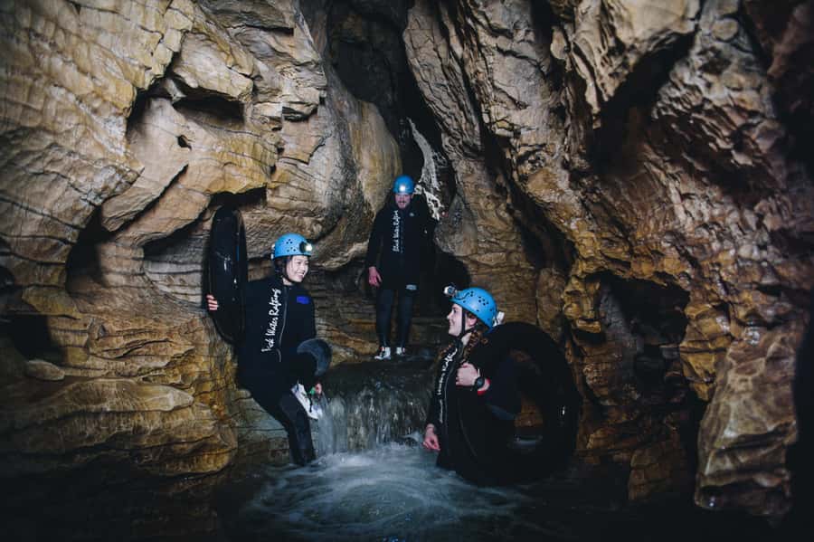 Waitomo Caves: Labyrinth Black Water Rafting Experience - Getting suited up for cold underground water